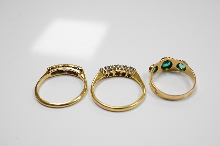 A group of three rings and a gold toothpick